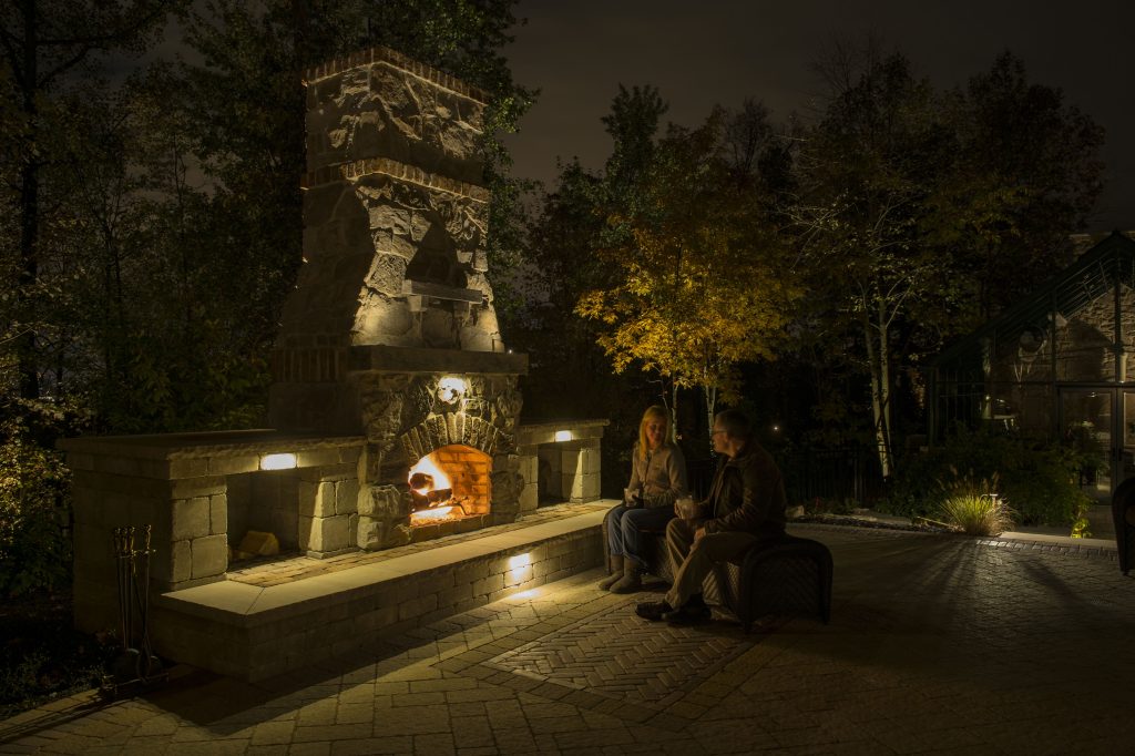 two people siting in outdoor living area at night